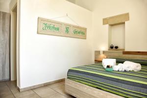 a bedroom with a bed with towels on it at Manipinta B&B in Corigliano dʼOtranto