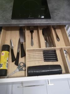 a drawer with knives and other kitchen utensils at Studio cosy tout confort proche aéroport et Paris in Choisy-le-Roi