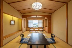 a dining room with a table and chairs at Kaike Tsuruya in Yonago