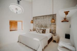 a bedroom with a white bed in a room at Sacred Hideaways in Tulum