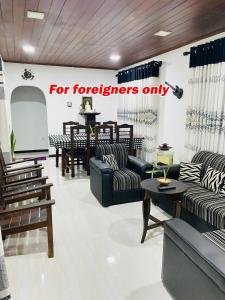 a for foreigners only store with couches and tables at NEWCINNAMONVILLA in Habaraduwa