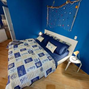 a blue bedroom with a bed with a blue wall at Útulné kondominium s vybavením 1 minutu od pláže in Cabarete