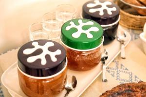 a group of four jars of honey on a plate at Manipinta B&B in Corigliano dʼOtranto +23 photos