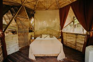 a bedroom with a bed in a tent at Sacred Hideaways in Tulum