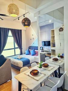 a living room with a bed and a table and chairs at Leisure2 Imperium Residence Kuantan Seaview Studio in Kuantan