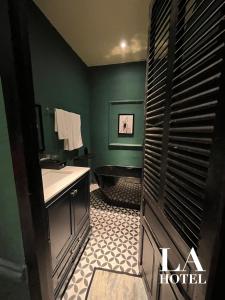 a bathroom with a toilet and a sink and a tub at La Hotel in Trung An
