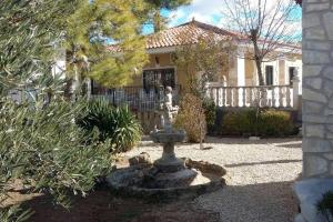 a fountain in the yard of a house at 3 bedrooms chalet with private pool terrace and wifi at La Almarcha in La Almarcha