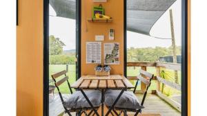 a table and chairs on the porch of a house at The Junction in Yarra Junction