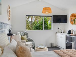 Country Idyll - Sandspit Holiday Cottage في Sandspit: غرفة معيشة مع أريكة ونافذة +10 صور