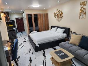 a hotel room with a bed and a couch at View Talay6 Mark Apartments in Pattaya