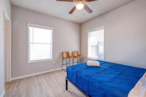 a bedroom with a blue bed and two chairs at Cozy 2BD Apt Austin Texas in Austin