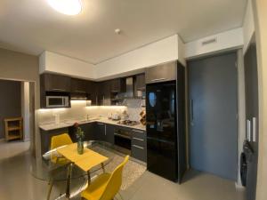a kitchen with a yellow table and yellow chairs at Luxurious 2 Bed @ The Tyrwhitt in Johannesburg