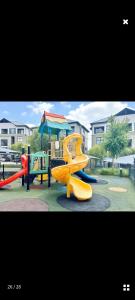 a playground with a yellow slide and a play structure at URlyfstyle Cottage @ Kikuyu waterfall in Midrand