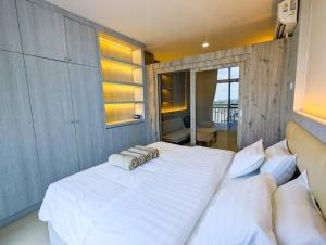 a bedroom with a large white bed with white pillows at Lovina 19-16 at Formosa Residence in Jodoh