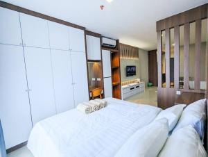 a large bedroom with a large white bed in it at Lovina 19-17 at Formosa Residence in Jodoh