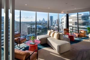 a living room with a view of a city at Dorsett Gold Coast in Gold Coast