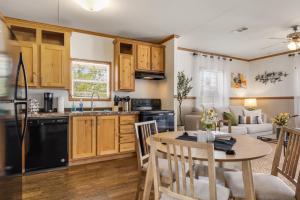 a kitchen and living room with a table and chairs at Hill Country Memories in Kerrville