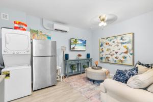 a living room with a refrigerator and a couch at Chic Downtown Home 42 And Guest Home 11 in West Palm Beach