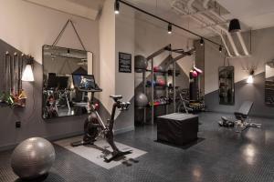 a room with a gym with bikes and exercise equipment at Moxy Portland Downtown in Portland