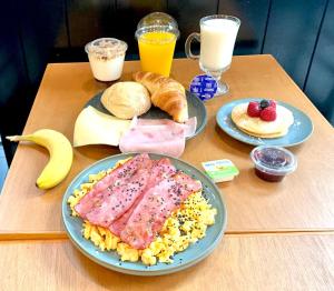 a wooden table with breakfast foods and drinks on it at Apartments Center Alfama in Lisbon