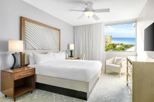 a bedroom with a bed and a window with the ocean at Marriott's Crystal Shores in Marco Island