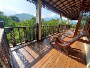 una terraza de madera con un banco encima en Hulu Tamu Off Grid Morrocan styled Hill Top Villa, en Kampong Sungai Tamu