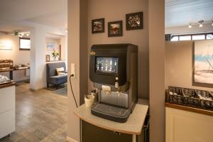 a barber shop with a laptop computer on a counter at WannerHus Hotel in Gr&ouml;mitz