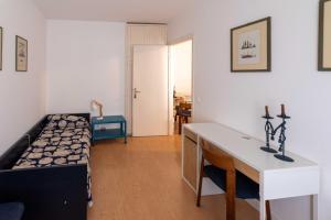 a bedroom with a bed and a desk in it at Sunny Home, appartamento in centro e vicino alla spiaggia in Grado