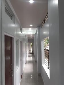 a hallway of a house with white walls and ceilings at Paul's Inn in Silchar