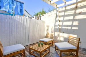 two chairs and a table with cactus on a patio at 2 Bedroom House Situated at the Centre of Surry Hills 2 E-Bikes Included in Sydney