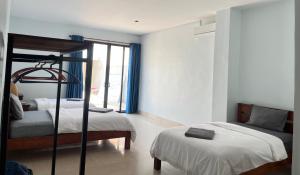 a bedroom with two beds and a window at Sorya Guesthouse & Dolphin Tours in Kratie
