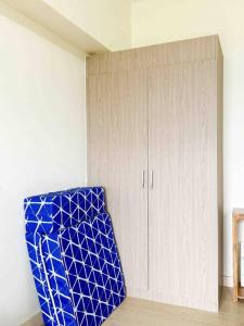 a room with a blue chair next to a cabinet at Nordic 1BR in Twin Lakes Tagaytay LL3-G in Tagaytay