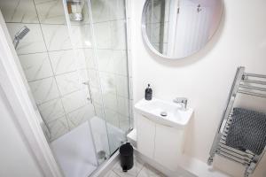 a white bathroom with a shower and a sink at Kings Arms Suites - Deluxe Room - En-Suite - Self Check In in Whitehaven