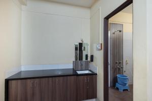 a bathroom with a counter and a blue toilet at Hotel Ambika in Kolhapur