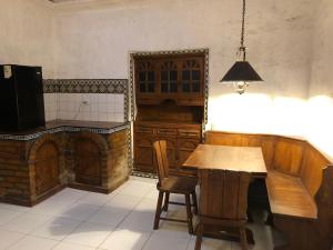 a kitchen with a wooden table and chairs and a fireplace at Studio Room with 2 Beds in Vibrant Arequipa City in Arequipa
