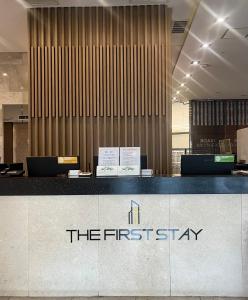 a hotel lobby with a counter with the firststay sign at First Stay Hotel in Seoul