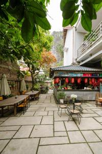 a patio with tables and chairs and a building at King Kong Homestay in Ninh Binh