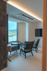 a living room with chairs and a couch and a table at Ocean Grand Hotel in Jeju