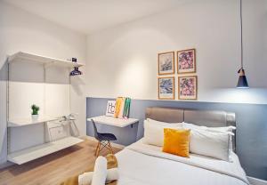 a bedroom with a bed and a desk with a chair at Arte Plus KLCC Designer Suites by Cobnb in Kuala Lumpur