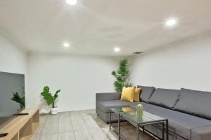 a living room with a couch and a table at Good for Family 3 Bedroom House Darlinghurst with 2 E-Bikes Included in Sydney