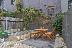 a table and chairs and a bench in a backyard at Good for Family 3 Bedroom House Darlinghurst with 2 E-Bikes Included in Sydney