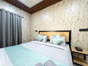 a bedroom with a large bed with blue pillows at Euphoric River Resort in Rishīkesh