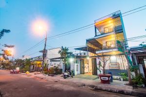 a street with a building on the side of the road at Tai Nhien Homestay in Tân Thành (1) +11 photos