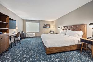 a hotel room with a bed and a desk at Four Points by Sheraton Jacksonville Baymeadows in Jacksonville