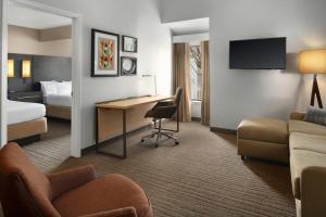a hotel room with a desk and a bed at Residence Inn Irvine Spectrum in Irvine +17 photos