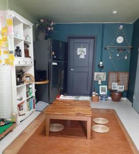 a living room with a table and a blue wall at Sodamhang in Damyang in Damyang