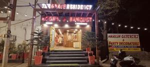 a restaurant with a sign on the front of it at The Grace Residency in Gurgaon