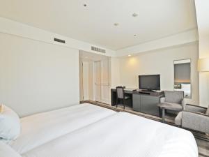 Ένα ή περισσότερα κρεβάτια σε δωμάτιο στο Chisun Grand Takayama