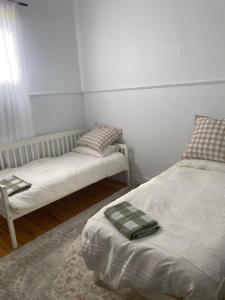 a room with two beds and a window at Freshly renovated gem - 1.5km from the city centre in Quarry Hill