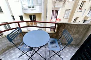 a blue table and two chairs on a balcony at Lilas Rose in Thonon-les-Bains